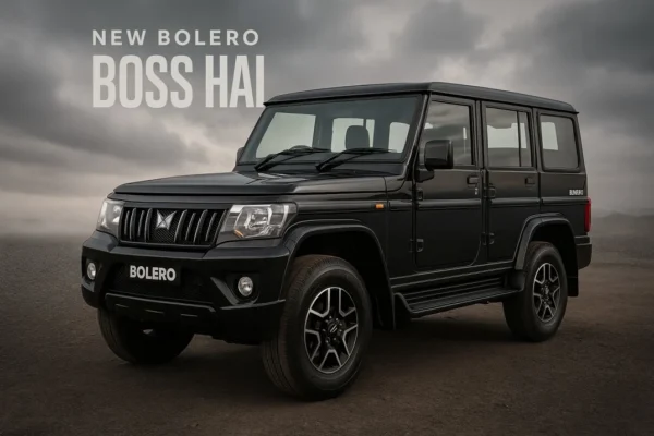 New 2025 Mahindra Bolero in black showcased on rugged terrain with bold “Boss Hai” branding in the background.